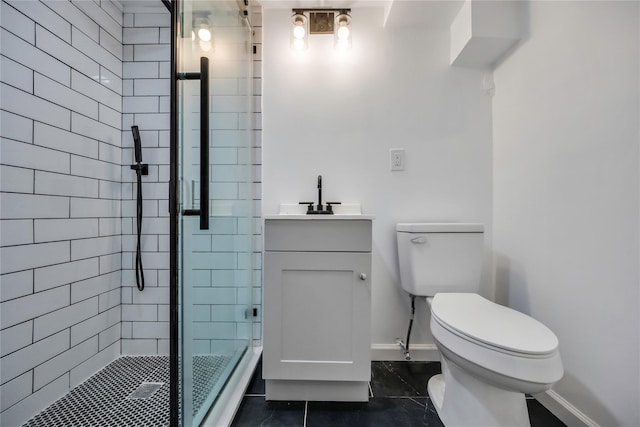 bathroom featuring vanity, toilet, tile patterned floors, and an enclosed shower