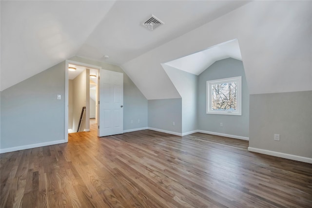 bonus room featuring hardwood / wood-style floors and lofted ceiling