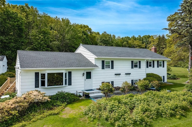 94 S Quaker Hill Rd, Pawling, NY 12564 - split level home with a chimney, roof with shingles, and a front lawn