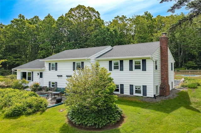 94 S Quaker Hill Rd, Pawling, NY 12564 - back of house with a chimney, a shingled roof, and a patio