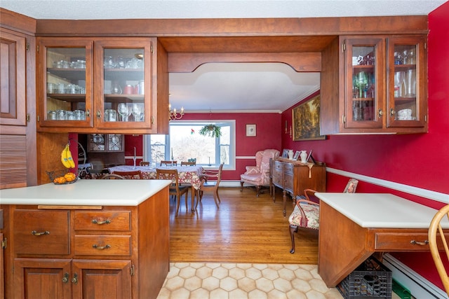 94 S Quaker Hill Rd, Pawling, NY 12564 - kitchen featuring light countertops, brown cabinets, glass insert cabinets, and light tile patterned floors