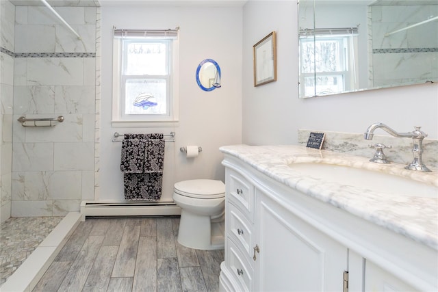 94 S Quaker Hill Rd, Pawling, NY 12564 - full bath featuring a baseboard heating unit, wood finished floors, vanity, and plenty of natural light