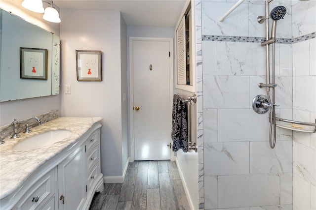94 S Quaker Hill Rd, Pawling, NY 12564 - full bathroom with vanity, wood finished floors, baseboards, and a tile shower