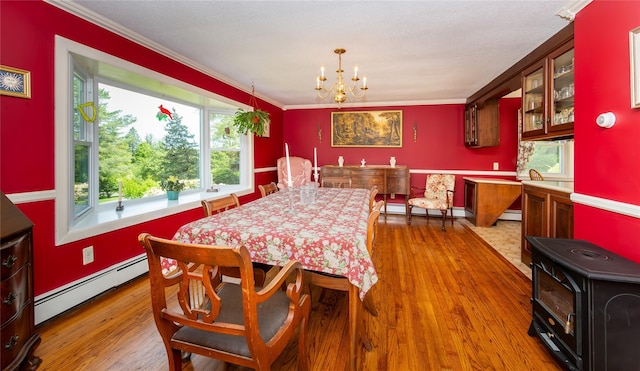 94 S Quaker Hill Rd, Pawling, NY 12564 - dining room with baseboard heating, plenty of natural light, ornamental molding, a chandelier, and wood finished floors