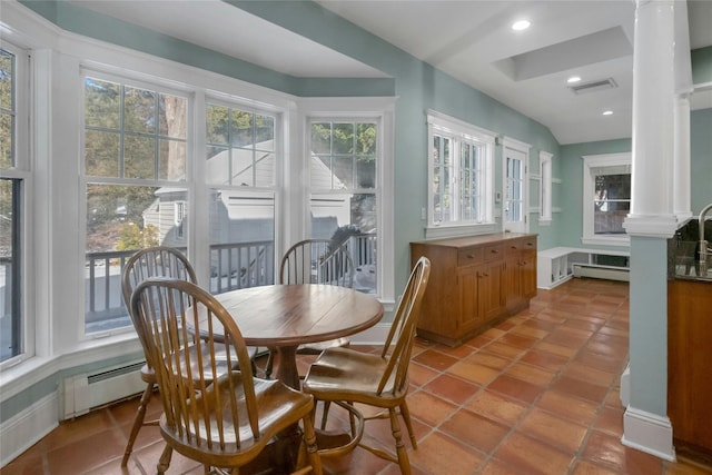 dining space featuring light tile patterned floors, a baseboard radiator, and ornate columns