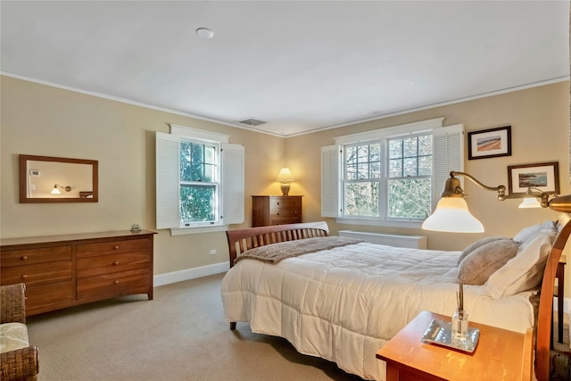 carpeted bedroom featuring crown molding and multiple windows