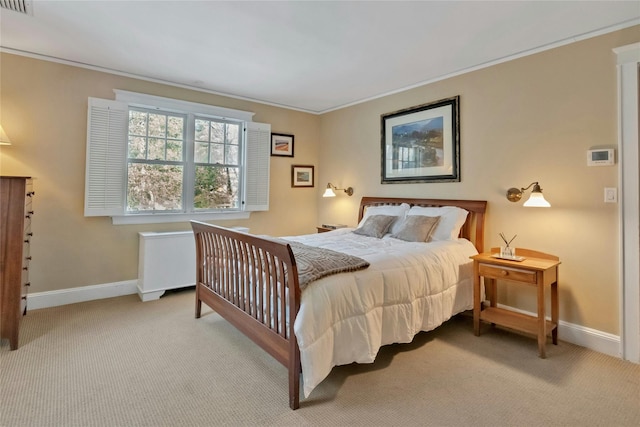 bedroom with crown molding and light colored carpet