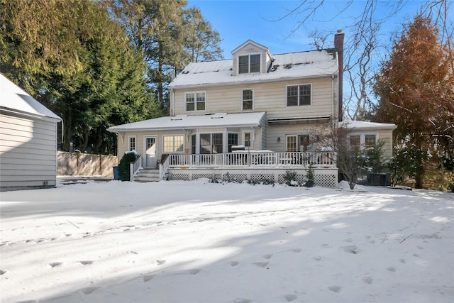 snow covered property featuring a deck