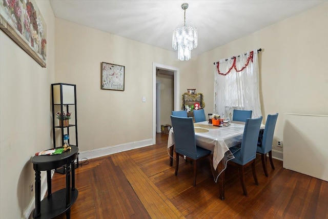 dining area with dark hardwood / wood-style flooring and a notable chandelier