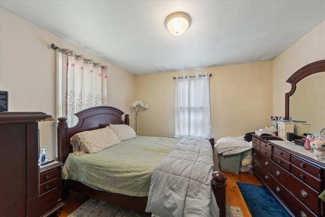 bedroom with dark wood-type flooring