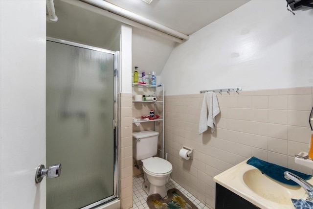 bathroom featuring toilet, an enclosed shower, tile walls, vanity, and tile patterned flooring