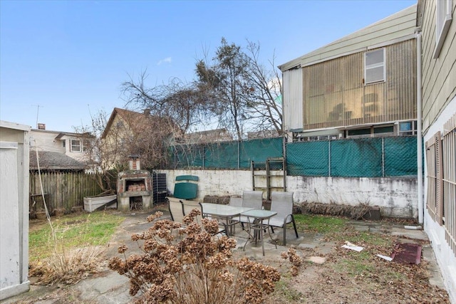 view of yard with a fireplace and a patio