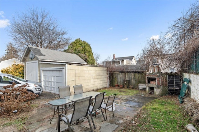 view of patio with a garage and an outdoor structure