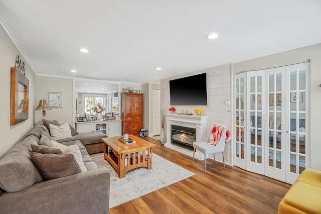 living room featuring wood-type flooring and ornamental molding