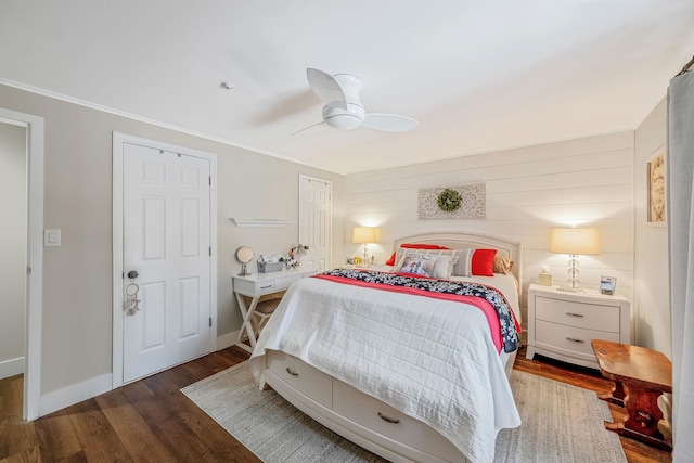 bedroom with crown molding, dark wood-type flooring, and ceiling fan