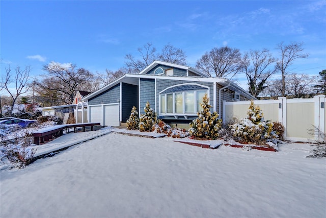 view of snow covered exterior with a garage