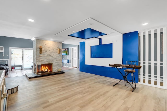 living area with light hardwood / wood-style flooring and a fireplace