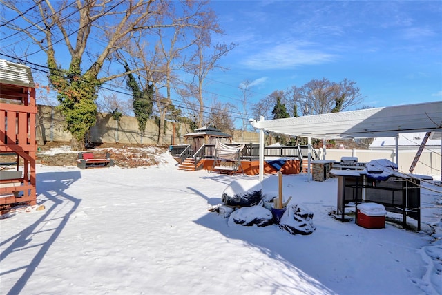 yard covered in snow with a hot tub