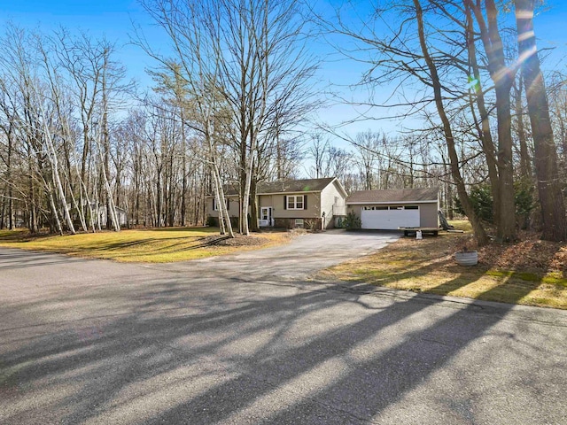 view of front of house with a garage and a front lawn