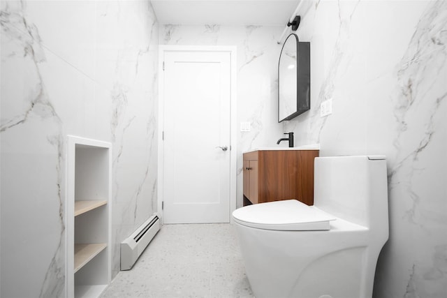 bathroom featuring baseboard heating, toilet, and vanity