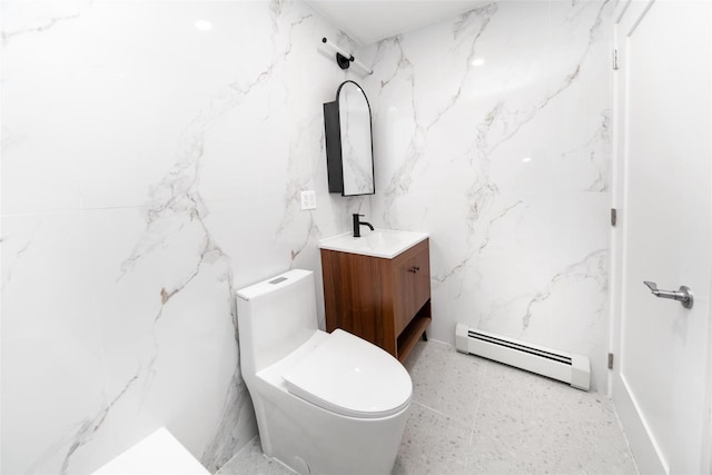 bathroom featuring a baseboard radiator, toilet, and vanity