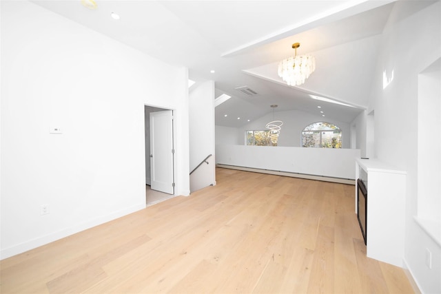 unfurnished living room with a notable chandelier, vaulted ceiling, light hardwood / wood-style flooring, and baseboard heating