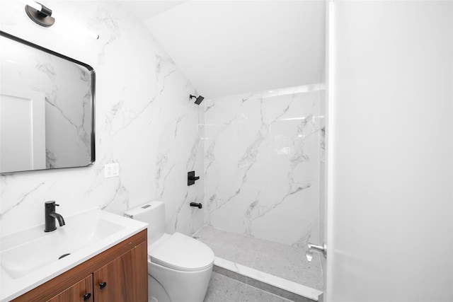 bathroom featuring vanity, toilet, tiled shower, and tile walls