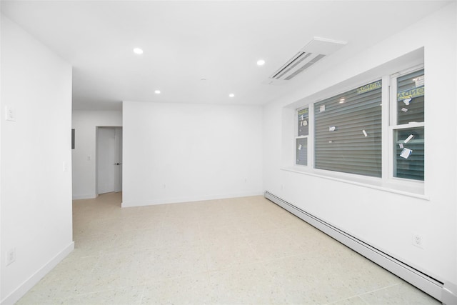 spare room featuring a baseboard heating unit