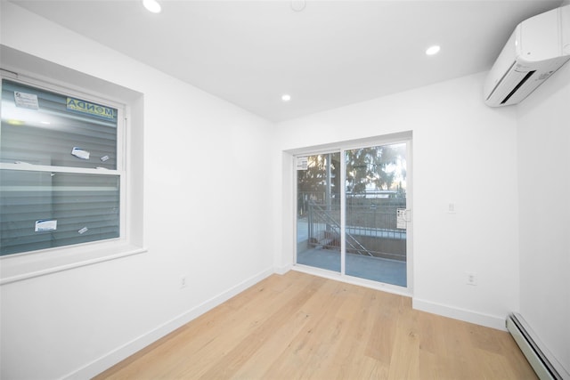 unfurnished room with light wood-type flooring, a wall mounted AC, and a baseboard radiator