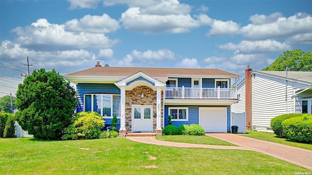 view of front of home with a balcony, a front yard, and a garage