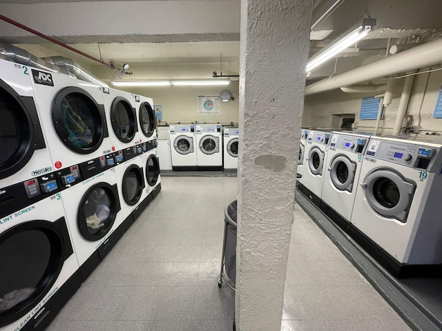 clothes washing area with washing machine and clothes dryer and stacked washer and clothes dryer