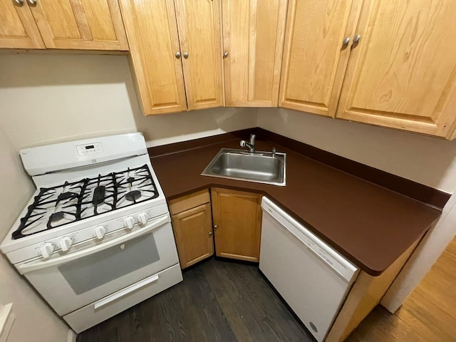 kitchen featuring sink, white appliances, and dark hardwood / wood-style floors