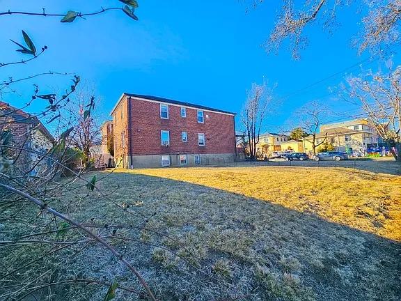 196-64 45th Ave, Flushing, NY 11358 - view of side of home featuring a lawn