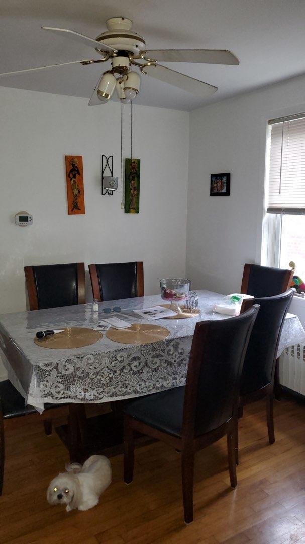196-64 45th Ave, Flushing, NY 11358 - dining area with ceiling fan, wood finished floors, and radiator