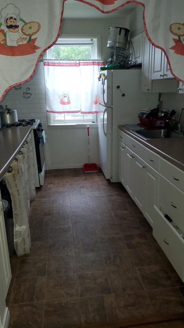 196-64 45th Ave, Flushing, NY 11358 - kitchen featuring stainless steel gas range oven, a sink, and white cabinetry