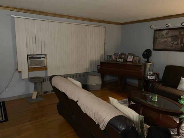 196-64 45th Ave, Flushing, NY 11358 - living room with wood finished floors, baseboards, and crown molding