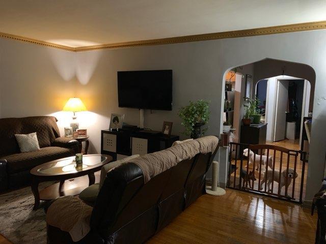 196-64 45th Ave, Flushing, NY 11358 - living area featuring wood finished floors, arched walkways, and ornamental molding
