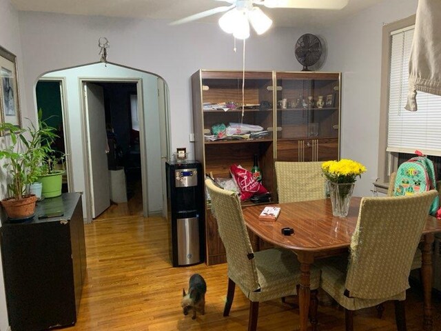 196-64 45th Ave, Flushing, NY 11358 - dining room featuring ceiling fan, light wood finished floors, and arched walkways