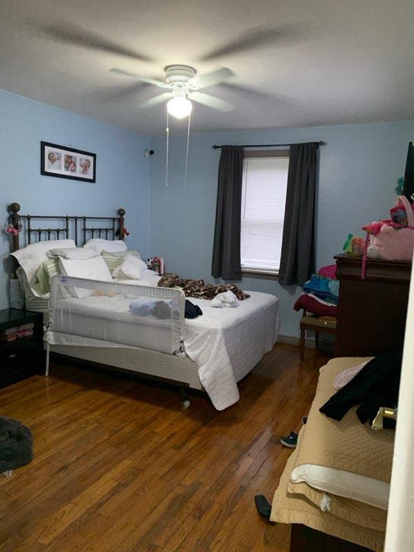 196-64 45th Ave, Flushing, NY 11358 - bedroom with wood finished floors and a ceiling fan