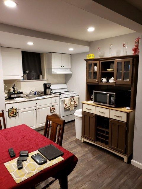 196-64 45th Ave, Flushing, NY 11358 - kitchen featuring white range with gas cooktop, stainless steel microwave, a sink, under cabinet range hood, and open shelves