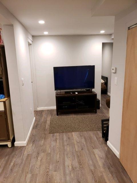 196-64 45th Ave, Flushing, NY 11358 - living area featuring wood finished floors, recessed lighting, and baseboards