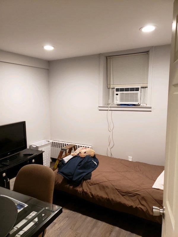 196-64 45th Ave, Flushing, NY 11358 - bedroom with radiator, cooling unit, wood finished floors, and recessed lighting