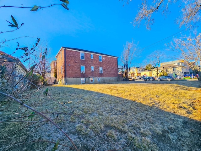 rear view of house featuring a yard