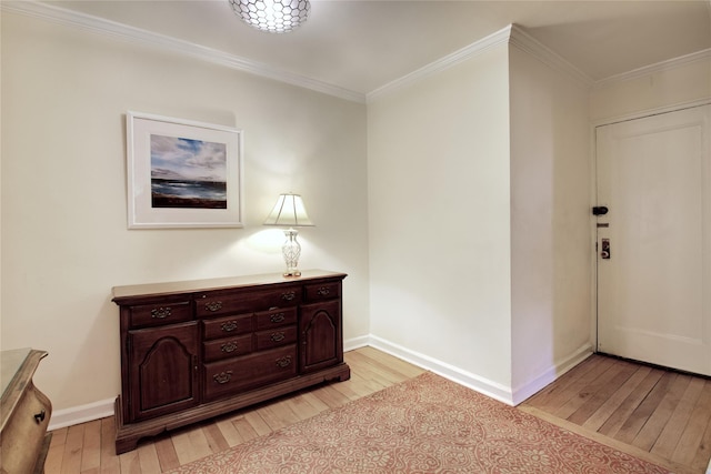 entrance foyer with crown molding and light hardwood / wood-style flooring