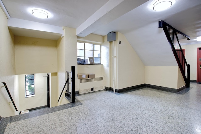 additional living space featuring radiator heating unit and a wealth of natural light