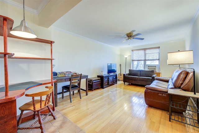 living area with a ceiling fan, crown molding, and light wood finished floors