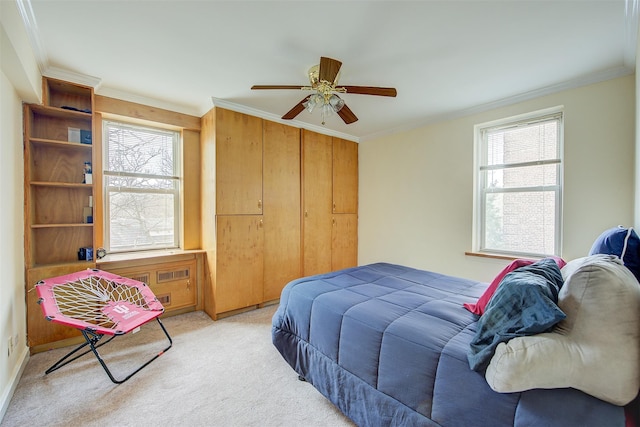 bedroom featuring light carpet, ceiling fan, and crown molding