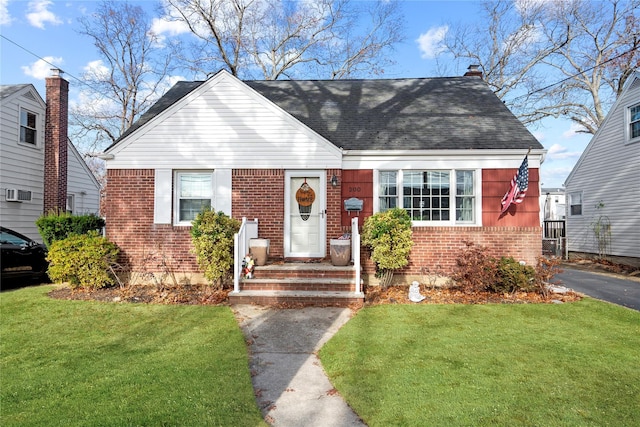 bungalow-style house with a front yard