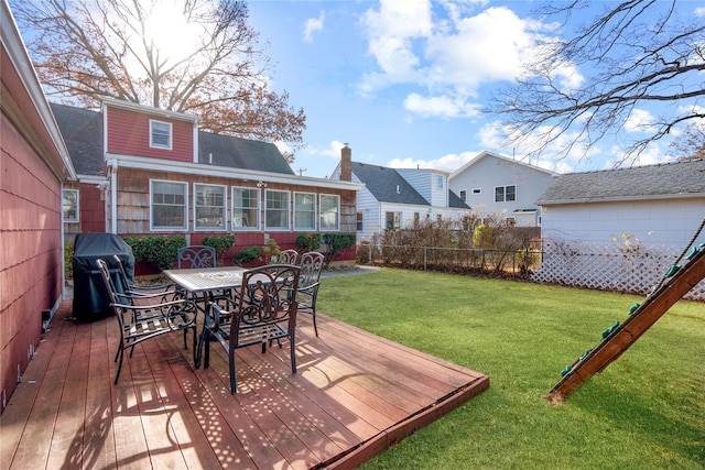 deck with grilling area and a yard