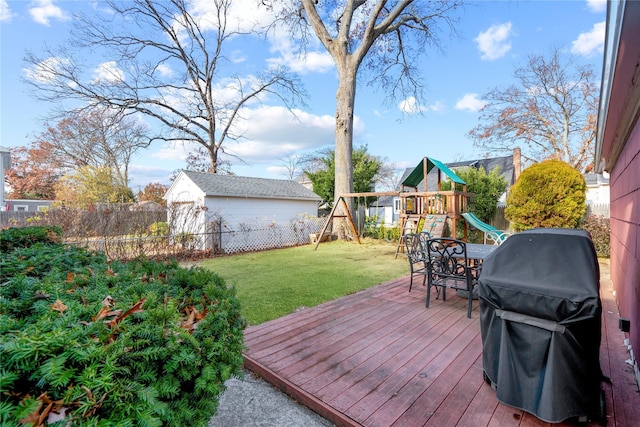 deck featuring a grill, a yard, and a playground